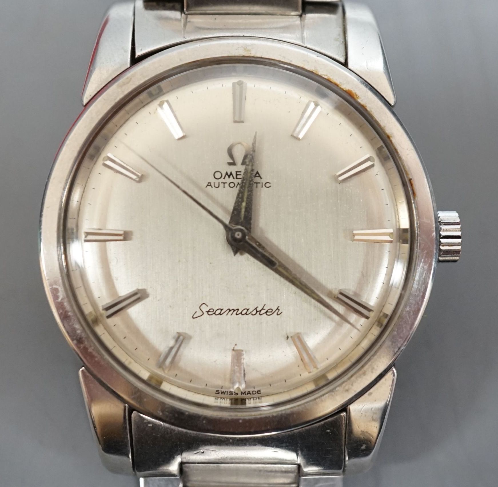 A gentleman's stainless steel Omega Seamaster Automatic wrist watch, on a stainless steel Omega bracelet, case diameter 34mm, box, no papers.